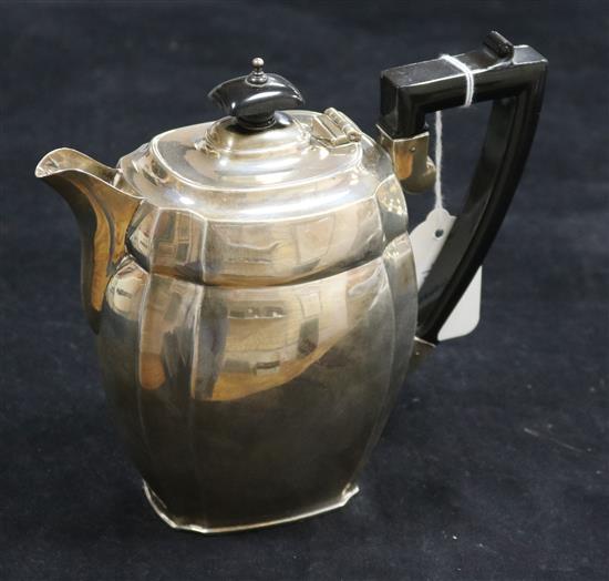 A silver teapot, of oval canted form with ebonised handle and finial, Chester 1936, S Blanckensee & Son Ltd, 16.4oz